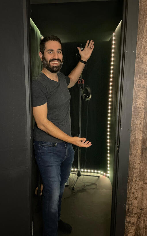 Andrew Dos Santos standing inside home-built voice over booth